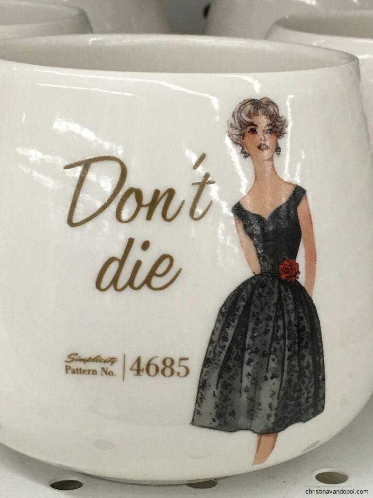 Mug with image of woman in black formal gown and text that says "Don't die"