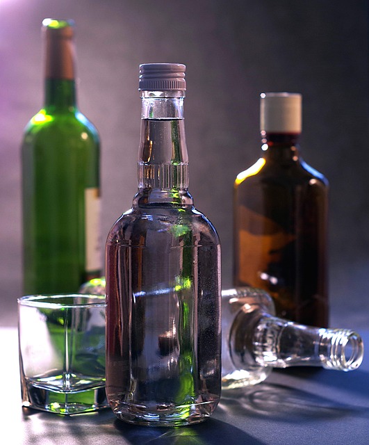 four bottles of alcohol with a glass