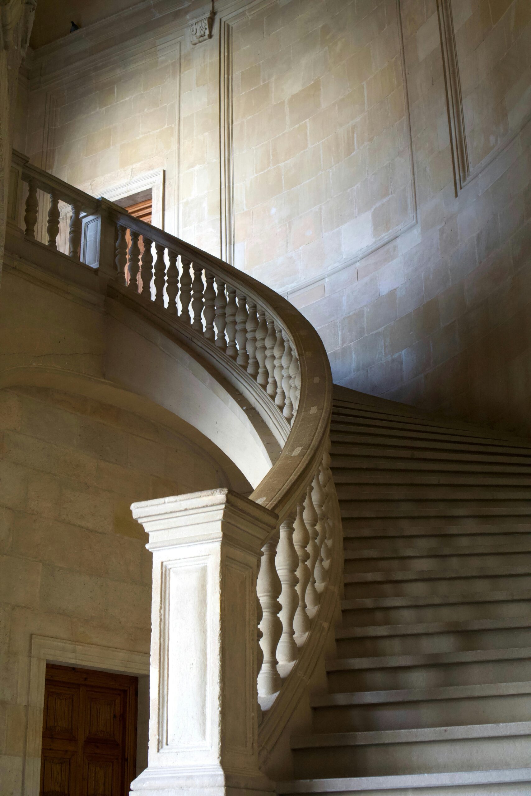 photo of a curving staircase with poor lighting that could be identified as the cause of a fall down stairs