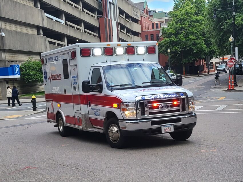 Photo of ambulance with lights on.