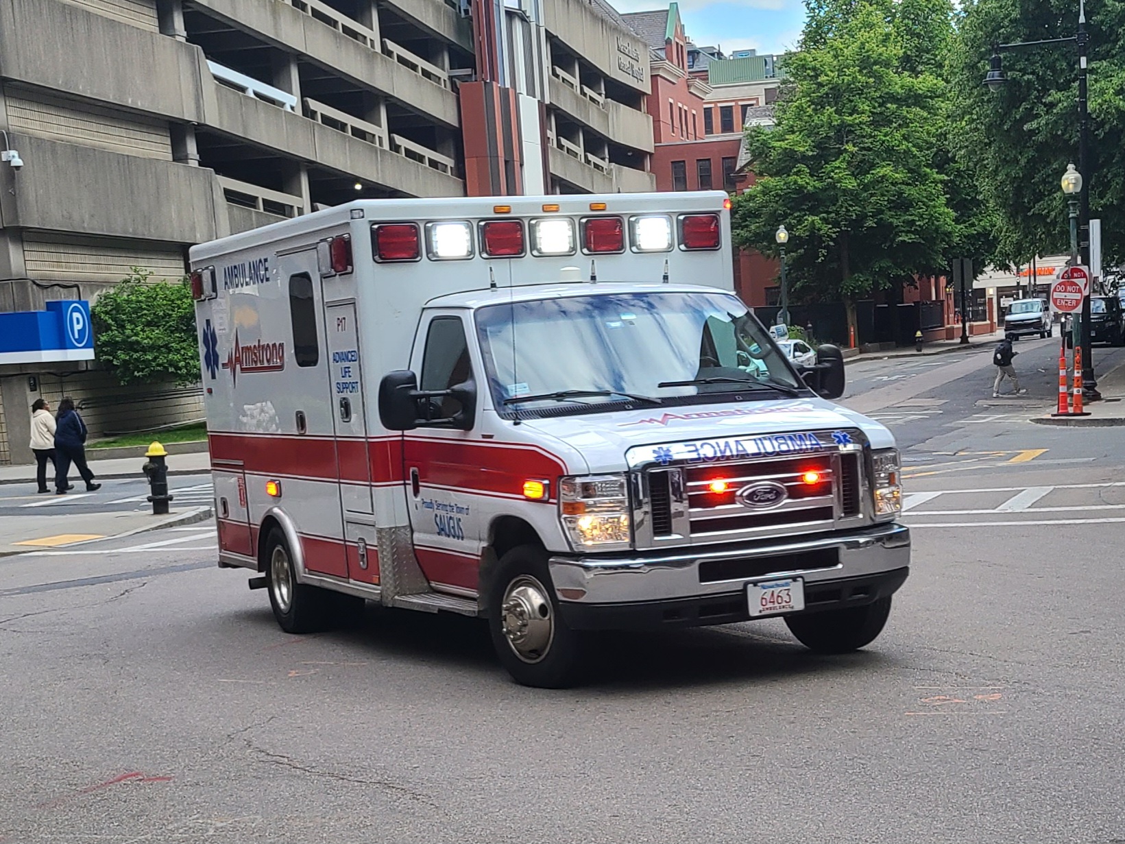 Photo of ambulance with lights on.