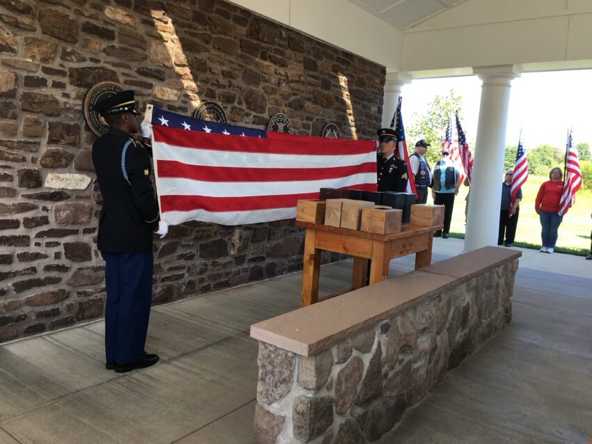 Photo of National Guard soldiers folding memorial U.S. flag at an Unattended Veterans Ceremony, at the Washington Crossing National Cemetery, 2019